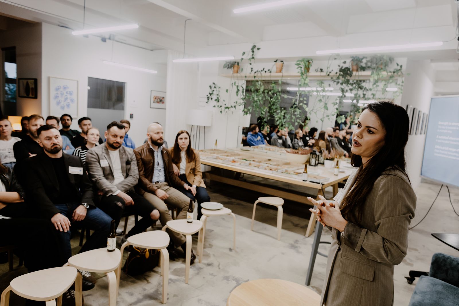 A speaker presenting to a seated audience at a Nexwork event space